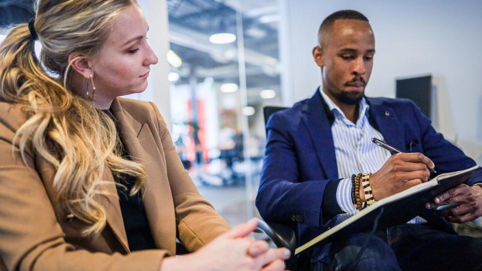 a male and female collaborating in an office