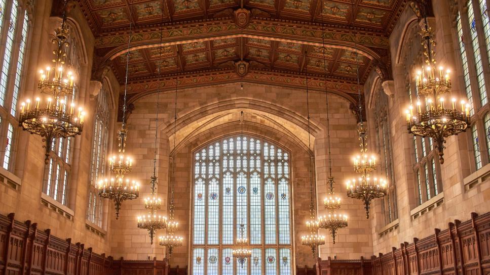 inside of a large building with lit chandeliers