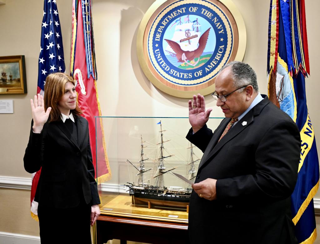 Image of Monica Dus being sworn in by the Secretary of the Navy