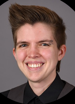 Headshot of Dr. Davidson in black shirt and gray vest
