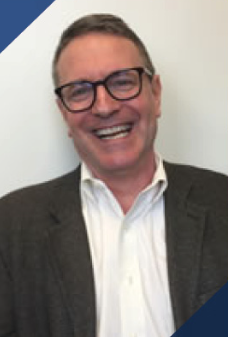 Headshot of Dr. Piette smiling with light colored background