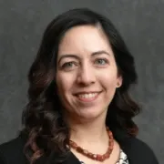 Headshot of Dr. Crandall in black blazer with red necklace
