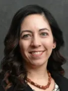 Headshot of Dr. Crandall in black blazer with red necklace