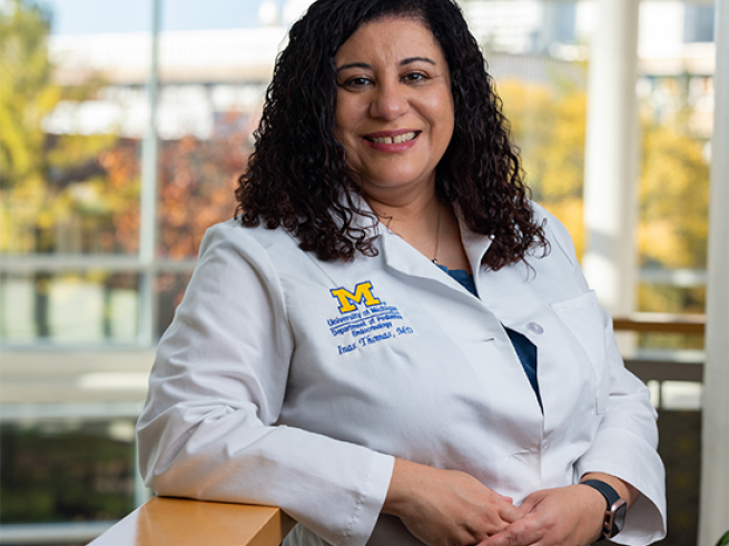 Headshot of Dr. Thomas in white coat with hands clasped