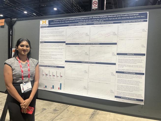 Statistician Lavanya Muthukumar, MS standing next to her poster at the event